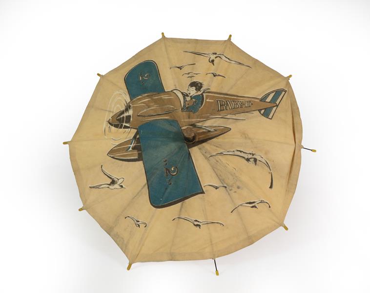 Lot 45 - A Second World War Child's Advertising Umbrella, the white cotton canopy printed with a boy...
