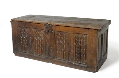 Lot 1595 - An Early 16th Century Carved Oak Chest, the hinged lid above four Gothic tracery carved panels,...