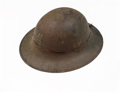 Lot 76 - A Second World War British Brodie Helmet, with original green finish, camouflage netting, liner...