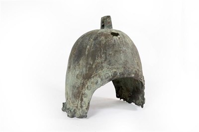 Lot 78 - A Chinese Western Zhou Style Bronze Helmet, with angular lug to the panelled crown, each ear flange