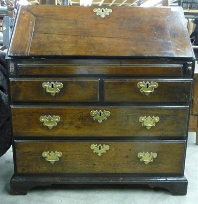 Lot 1602 - An 18th Century Oak Bureau, the fall enclosing a fitted interior of pigeon holes above three...