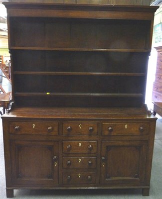 Lot 1605 - An Early 19th Century Enclosed Dresser and Rack, with three fixed shelves above an arrangement...