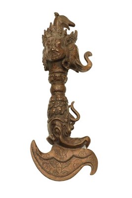 Lot 160 - A Nepalese Bronze Phurba (Ritual Dagger), with crescent shape blade, the haft and pommel cast...
