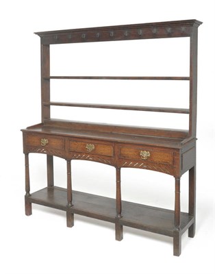 Lot 1612 - A George III Open Dresser and Rack, mid 18th century, with three fixed shelves and iron cup...