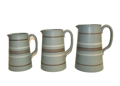 Lot 13 - A set of three graduating Wedgwood water jugs, largest 18cm, and a pair of mottled glass vases,...