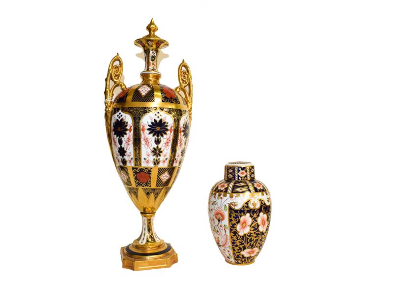 Lot 21 - A Royal Crown Derby twin handled vase in Imari pattern (a.f.) and a small vase and cover (2)