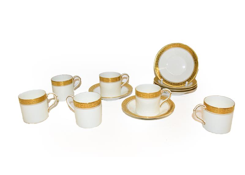 Lot 71 - A set of six Royal Worcester coffee cans and saucers decorated with gilt and scrolling, date...
