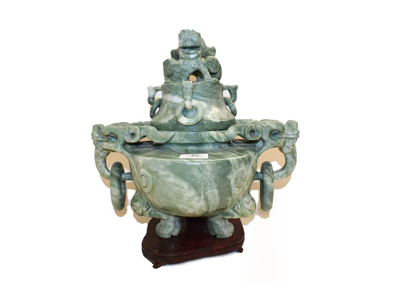 Lot 82 - A 20th century Chinese green hardstone vase and cover, with twin ring and mask handles on...