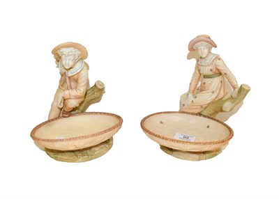 Lot 99 - A pair of Royal Worcester comports, modelled as a girl and a boy, puce marks, 21cm