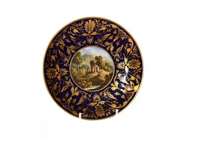 Lot 114 - A Derby saucer dish, circa 1800, central painted scene of a view in Switzerland, 21.5cm diameter