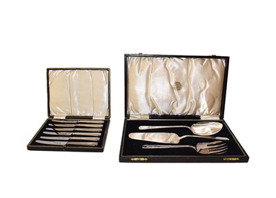 Lot 117 - A set of brass letter scales and four cased cutlery sets to include fish knives and forks,...
