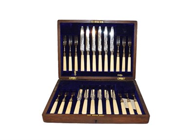Lot 117 - A set of brass letter scales and four cased cutlery sets to include fish knives and forks,...