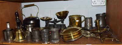 Lot 129 - Pewter tankards, brass hand bells, scales, brassware, etc (one shelf)