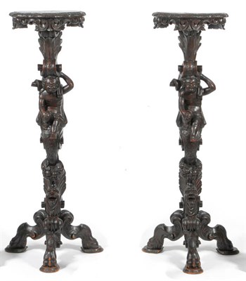 Lot 1629 - A Pair of 19th Century Italian Walnut and Pine Torcheres, each richly carved with C scroll...