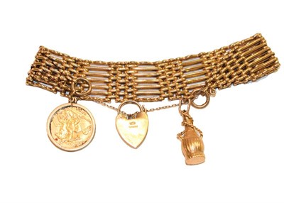 Lot 179 - A gate link bracelet, stamped '9' and '.375', hung with a 1914 half sovereign and a further...