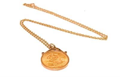 Lot 202 - A gold full sovereign mounted in a 9 carat gold setting and attached with a chain with clasp...