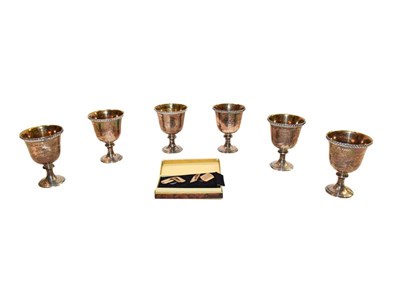 Lot 240 - Six silver egg cups and a pair of 9 carat gold and silver cufflinks (cased)