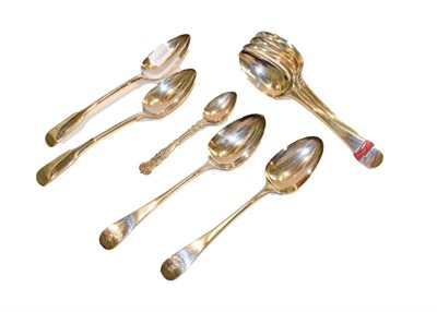 Lot 250 - A selection of George III and 19th century silver table spoons and tea spoons, 886 grams