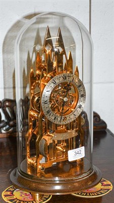 Lot 342 - A brass cathedral form skeleton mantel timepiece, signed Elliott, London, beneath glass dome