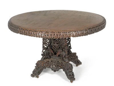 Lot 1647 - An Anglo-Indian Carved Hardwood Circular Dining Table, late 19th century, probably Bombay, with egg