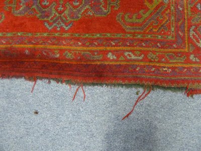 Lot 1011 - An Ushak Rug, the tomato red field with three medallions enclosed by multiple narrow borders, 245cm