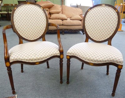 Lot 1662 - A Set of Ten Louis XVI Style Stained Beechwood Dining Chairs, of recent date, upholstered in floral