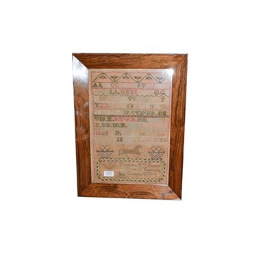 Lot 1121 - A framed embroidered table cloth, a woolwork sampler worked by Barbara Munro 1871 an a mirror (3)
