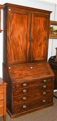 Lot 1134 - A George III mahogany bureau bookcase with string inlay and fitted interior, 105cm by 58cm by 220cm