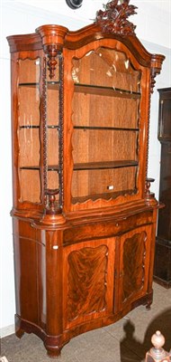 Lot 1139 - A Biedermeier mahogany serpentine display cabinet, with carved pediment, twist supports and...