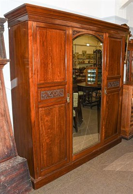 Lot 1144 - An Edwardian mahogany mirror fronted triple wardrobe, with carved scroll work, 196cm by 54cm by...