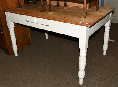 Lot 1156 - A pine single drawer kitchen table with painted base, raised on turned supports, 136cm by 86cm...