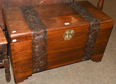 Lot 1166 - A Chinese camphor wood chest, carved with bands of dragons and cloud scrolls, 90cm by 46cm by 50cm