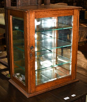 Lot 1170 - A 19th century oak shop counter top display cabinet, the bevelled glass panels with later...