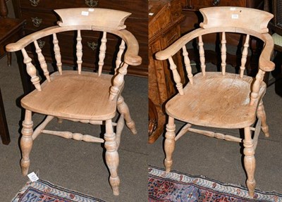 Lot 1172 - A pair of 19th century elm bow backed armchairs with raised backs and scroll arms, 80cm high