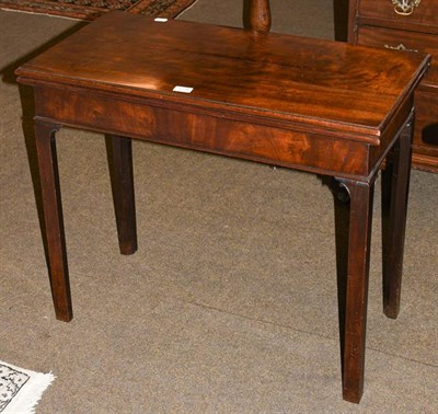 Lot 1174 - A George III mahogany foldover card table, raised on plain square supports, 80cm by 40.5cm by 68cm