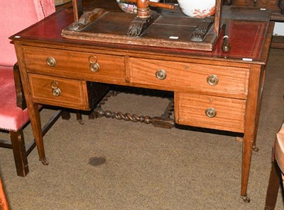 Lot 1182 - An Edwardian inlaid mahogany kneehole writing desk with inset leather top, raised on square...