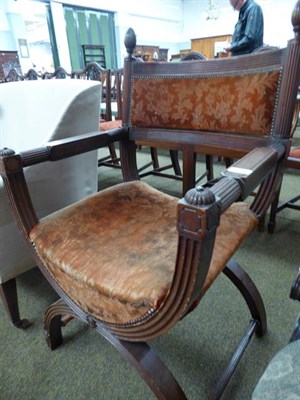 Lot 1184 - A Victorian carved mahogany X framed armchair, with reeded mouldings and velvet upholstery,...