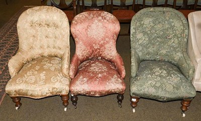 Lot 1186 - A pair of Victorian upholstered tub chairs raised on turned mahogany supports, together with a...
