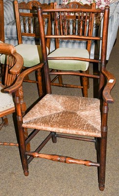 Lot 1191 - A 19th century ash spindle back country armchair with rush seat