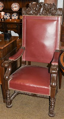 Lot 1199 - WWII Interest: A heavily carved boardroom armchair with studded leather upholstery, the deep...