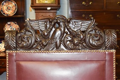 Lot 1199 - WWII Interest: A heavily carved boardroom armchair with studded leather upholstery, the deep...