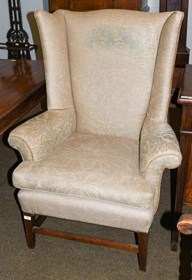 Lot 1201 - A 19th century wing chair on mahogany supports, 87cm by 70cm by 117cm