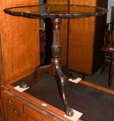 Lot 1224 - A George III mahogany dish top tripod table, with reeded pedestal and acanthus carved scrolling...