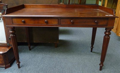 Lot 1676 - A Mahogany Washstand or Writing Table, in the manner of Gillows, circa 1830, the three-quarter...