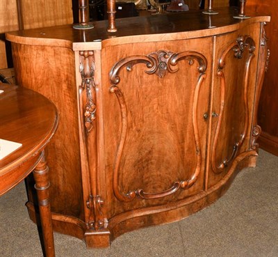 Lot 1226 - A Victorian walnut chiffonier of serpentine form with carved scroll supports (the back...