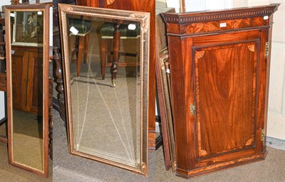 Lot 1239 - A George III inlaid mahogany corner cupboard, together with a gilt framed bevelled mirror, and...