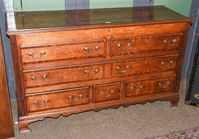Lot 1247 - A George III oak Lancashire chest crossbanded in mahogany, with reeded moulding and raised on...