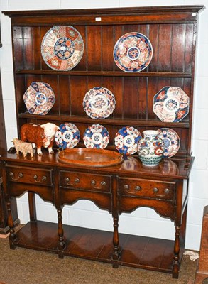 Lot 1253 - A reproduction oak dresser and rack with pot board, 140cm by 44cm by 183cm