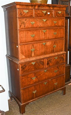 Lot 1255 - An 18th century walnut chest on chest, crossbanded and oak lined, with brass handles, raised on...