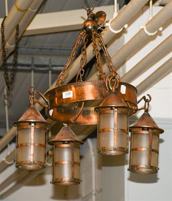 Lot 1259 - An Arts and Crafts copper hanging electrolier, comprising four lanterns